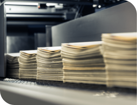 Stacks of printed pages on a printing press